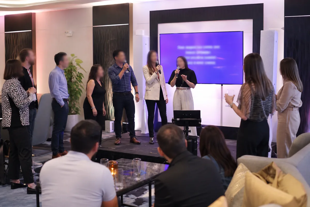 Corporate team event with colleagues enjoying karaoke and presentation screens